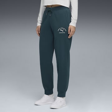 PUMA Tapered Sports trousers in Green: front