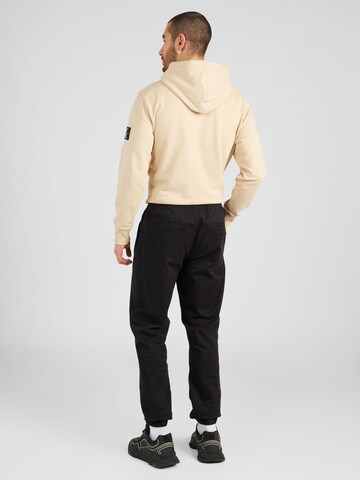 Tommy Jeans Tapered Byxa 'AUSTIN' i svart