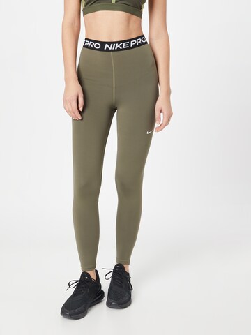 NIKE Skinny Workout Pants in Green: front