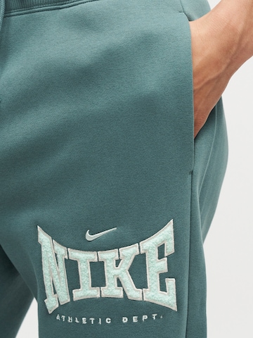Nike Sportswear Szeroka nogawka Spodnie 'PHX' w kolorze zielony