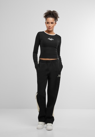 Loosefit Pantaloni con piega frontale di Karl Kani in nero