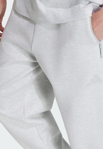ADIDAS SPORTSWEAR Zúžený strih Športové nohavice 'Z.N.E.' - Sivá