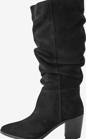 Next Saappaat värissä musta: etupuoli