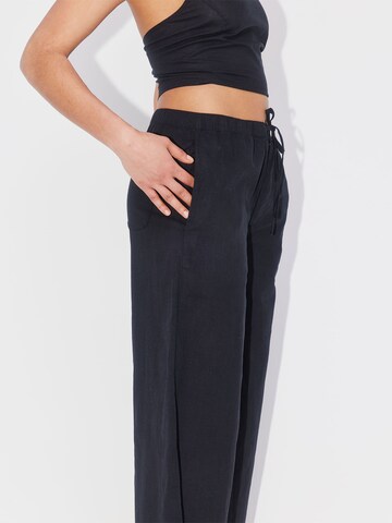 ABOUT YOU REBIRTH STUDIOS Wide leg Pants 'Holiday' in Black