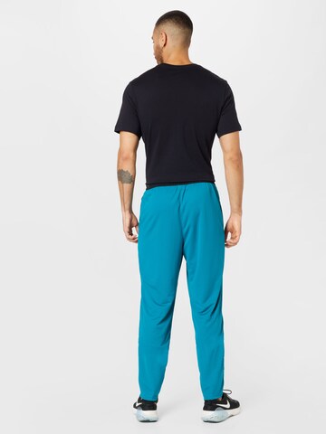 Effilé Pantalon de sport NIKE en bleu