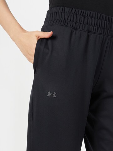 UNDER ARMOUR Tapered Sports trousers 'Meridian' in Black