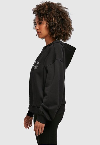 Merchcode Sweatshirt 'Spring - Feels like' in Schwarz
