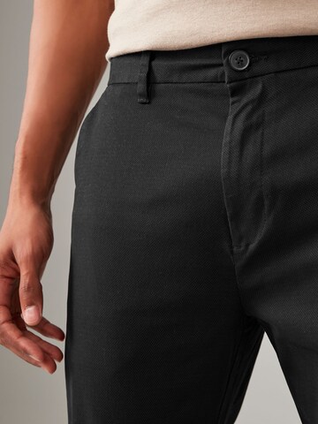 Slimfit Pantaloni chino di Next in nero