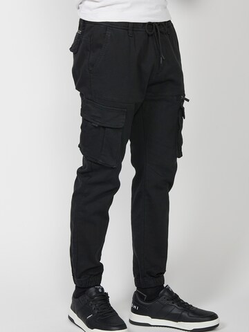 KOROSHI Tapered Cargo trousers in Black: front