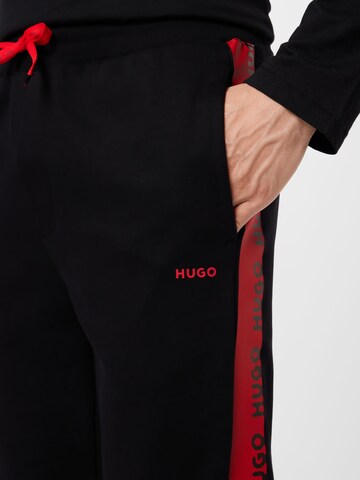 Tapered Pantaloni 'Darpaccio' di HUGO Red in nero