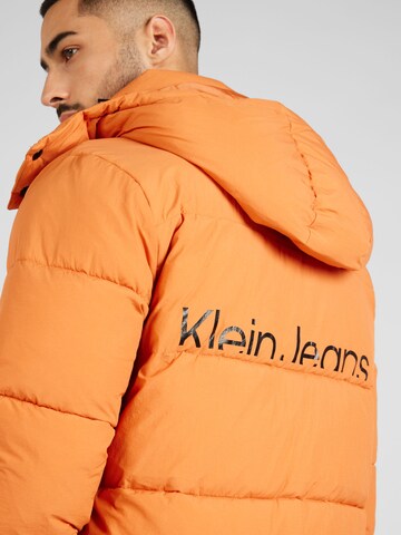 Calvin Klein Jeans Преходно яке 'Essential' в оранжево