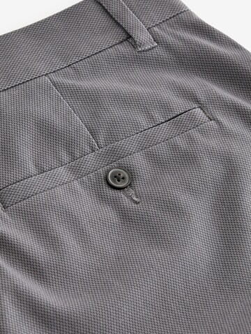 Slimfit Pantaloni chino di Next in grigio
