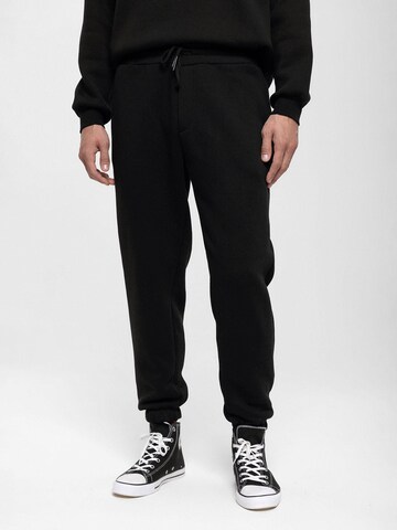 Antioch Tapered Pants in Black: front