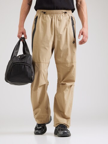 Tapered Pantaloni 'Tech' de la Nike Sportswear pe bej: față
