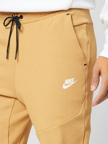 Nike Sportswear Tapered Trousers in Beige