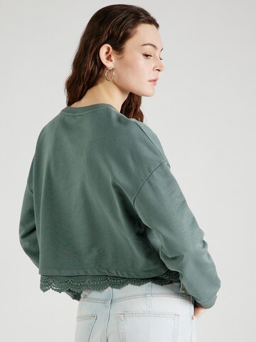 Sweat-shirt 'Georgeia' ABOUT YOU en vert