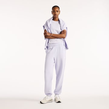 Tapered Pantaloni 'Sport Essentials French Terry Jogger' di new balance in lilla