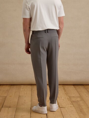 DAN FOX APPAREL Tapered Trousers with creases 'Toni' in Grey