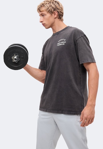 UNDER ARMOUR Performance Shirt 'PROPERTY OF UA' in Black