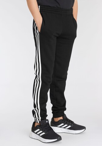 ADIDAS SPORTSWEAR Конический (Tapered) Спортивные штаны 'Essentials' в Черный