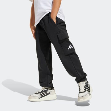 ADIDAS SPORTSWEAR Tapered Workout Pants in Black: front