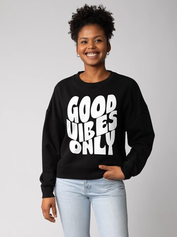 Felpa 'Good vibes only ' di Watapparel in nero: frontale