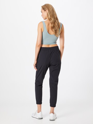 Tapered Pantaloni sportivi 'Halden' di ODLO in nero