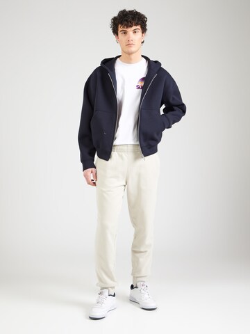 Superdry Zwężany krój Spodnie 'Essential' w kolorze beżowy