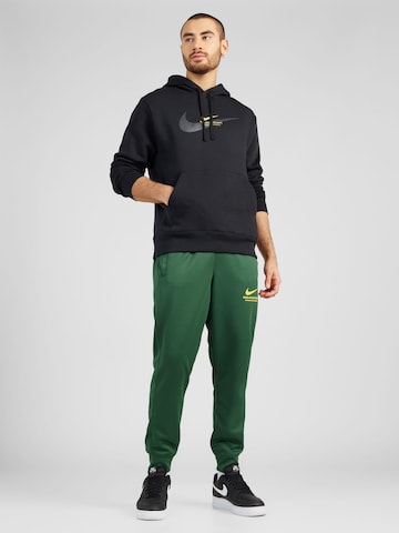 Nike Sportswear Tapered Housut värissä vihreä