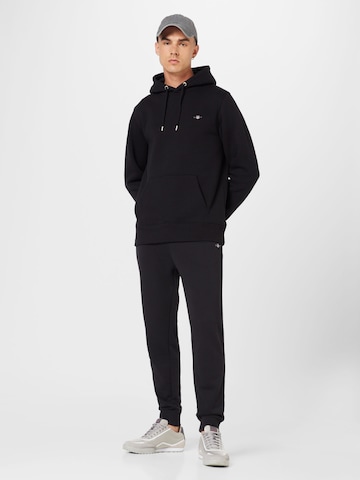 GANT Tapered Housut värissä musta