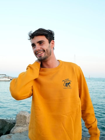 Surf Monkey Sweatshirt 'Rette das Ozean' in Orange