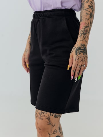 ABOUT YOU x Sharlota Regular Pants 'Tessa' in Black