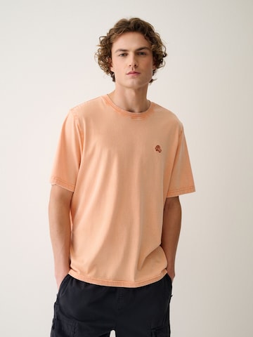 Next T-Shirt in Orange: Vorderseite