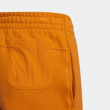 ADIDAS ORIGINALS Tapered Pants 'Ivy Park' in Orange