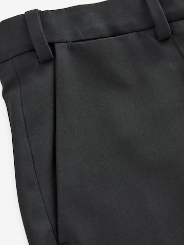 Slimfit Pantaloni con piega frontale di Next in nero