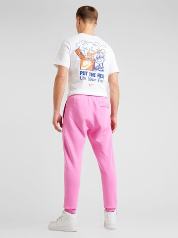 Nike Sportswear Tapered Housut 'Club Fleece' värissä vaaleanpunainen