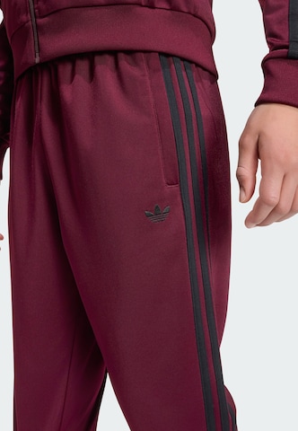 Tapered Pantaloni 'SST' di ADIDAS ORIGINALS in rosso