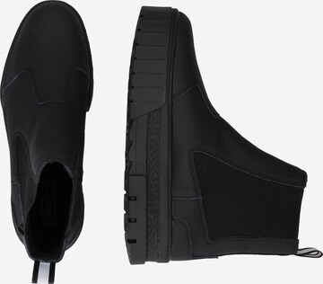 PUMA - Botas Chelsea en negro