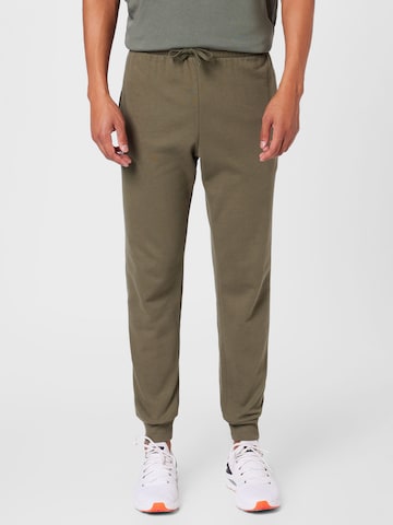 UNDER ARMOUR Tapered Workout Pants in Green: front