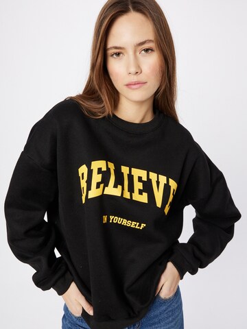Sweat-shirt 'Believe' Edikted en noir