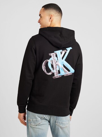 Sweat-shirt Calvin Klein Jeans en noir : devant