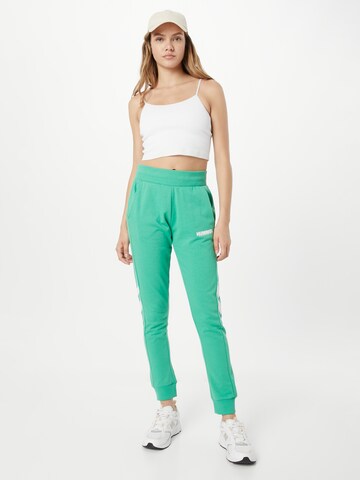 Effilé Pantalon de sport Hummel en vert