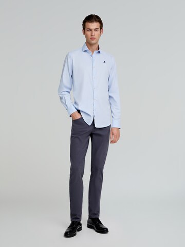 Scalpers Slim fit Trousers 'Nos' in Blue: front