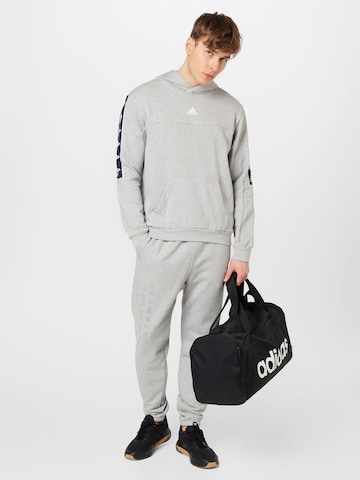 Effilé Pantalon de sport 'Lounge Fleece' ADIDAS SPORTSWEAR en gris