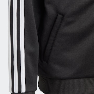 ADIDAS SPORTSWEAR Спортна жилетка с качулка 'Essentials' в черно