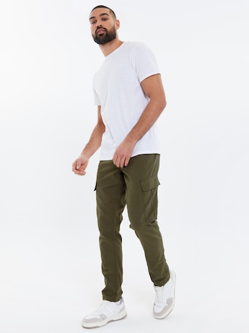 Evazați Pantaloni cu buzunare 'Gordon' de la Threadbare pe verde