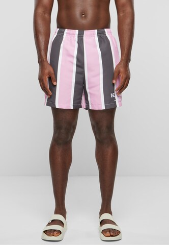 Karl Kani Board Shorts in Pink: front