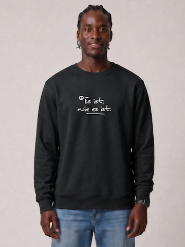 Watapparel Sweatshirt 'Es Ist Wie Es Ist' in Zwart: voorkant