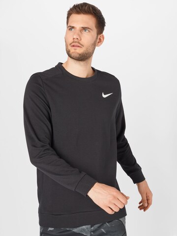 NIKE - Camiseta deportiva en negro: frente