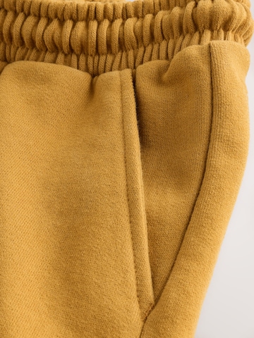 Next Tapered Housut värissä keltainen